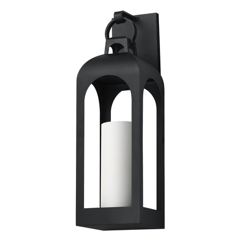 A black metal lantern-style wall sconce with a white cylindrical candle insert, shown against a plain white background.