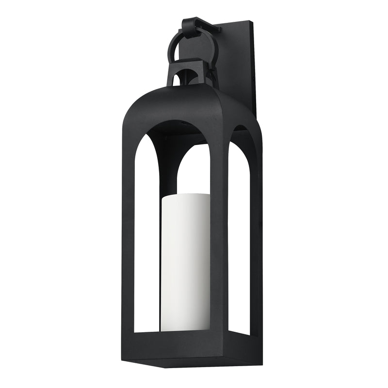 A black metal lantern-style wall sconce with a white cylindrical candle insert, shown against a plain white background.