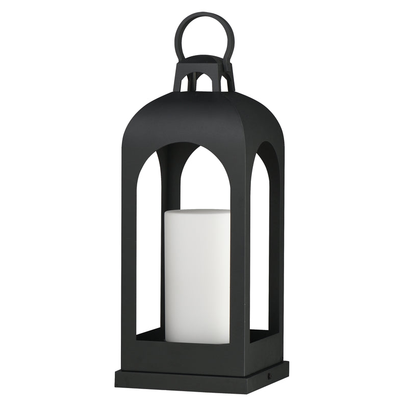 A black metal lantern with a top handle and a white pillar candle inside, shown on a plain white background.