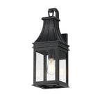 Black outdoor wall lantern with clear glass on a white background