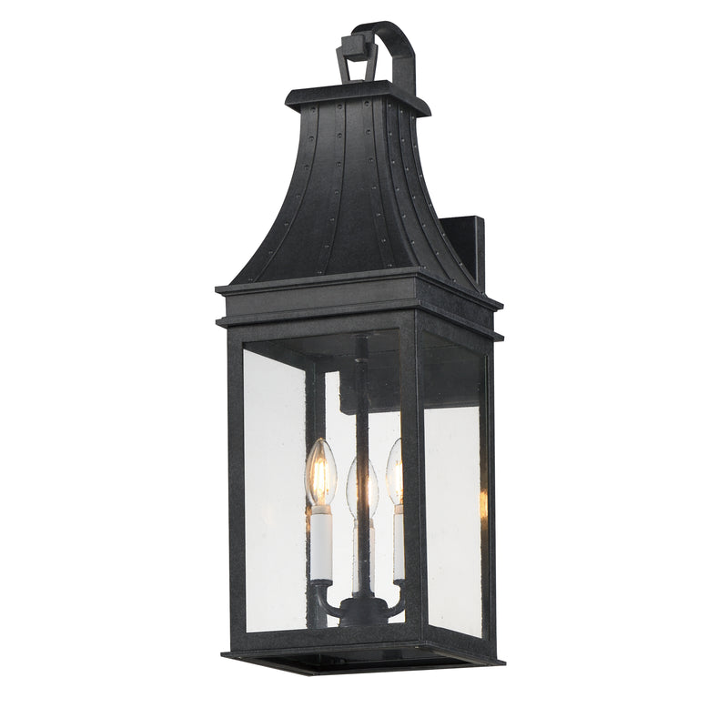 Black outdoor wall lantern with clear glass on a white background