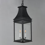 A black metal lantern-style pendant light with clear glass panels and two visible candle-style bulbs, hanging against a plain light gray background.