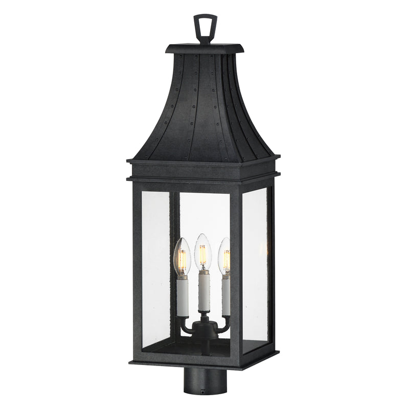 A black outdoor lantern-style wall light with three candle-style bulbs visible inside clear glass panels, shown against a plain white background.