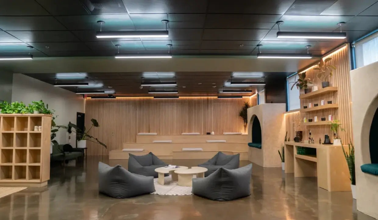 4FT LED direct and indirect suspended linear fixtures installed in a commercial office space with open ceiling and workstations