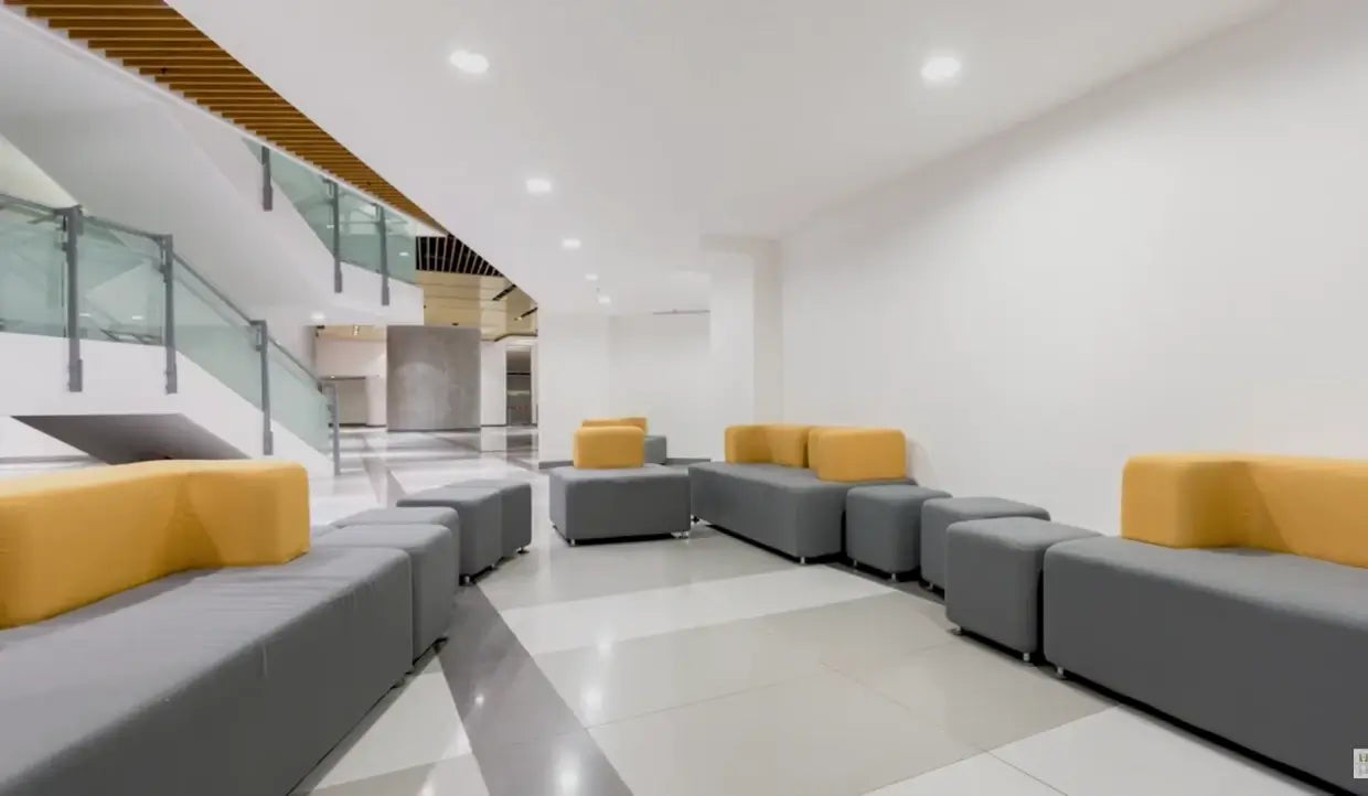 6-inch LED round commercial downlights installed in a modern building lobby ceiling above the seating area