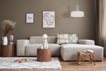 Modern living room with a gray sofa, wooden coffee table, and decorative elements.