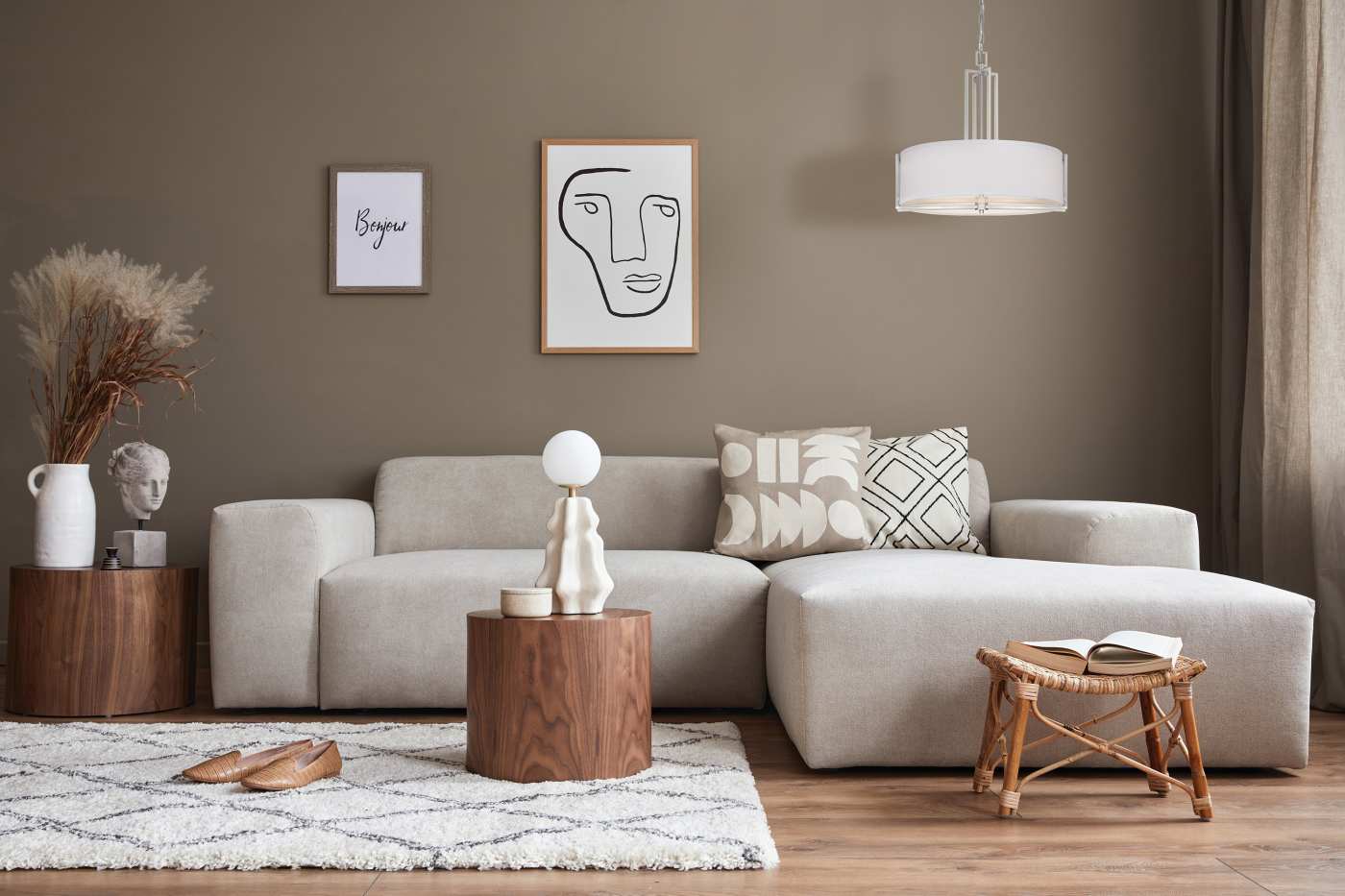 Modern living room with a gray sofa, wooden coffee table, and decorative elements.