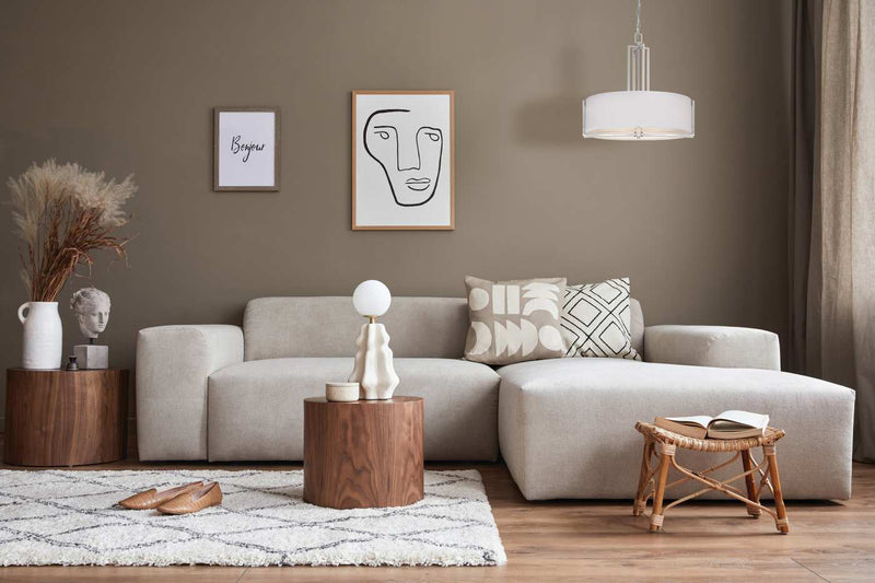 Modern living room with a gray sofa, wooden coffee table, and decorative elements.