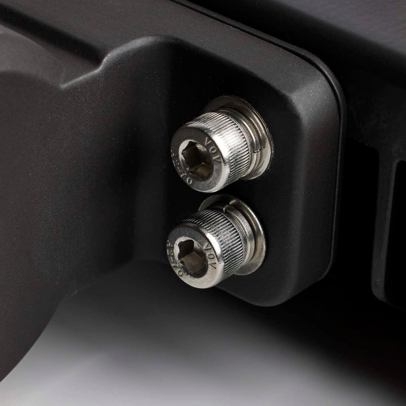 Close-up of two metal screws on a black mechanical component.