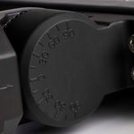 Close-up of a black adjustable wrench handle with measurement markings.