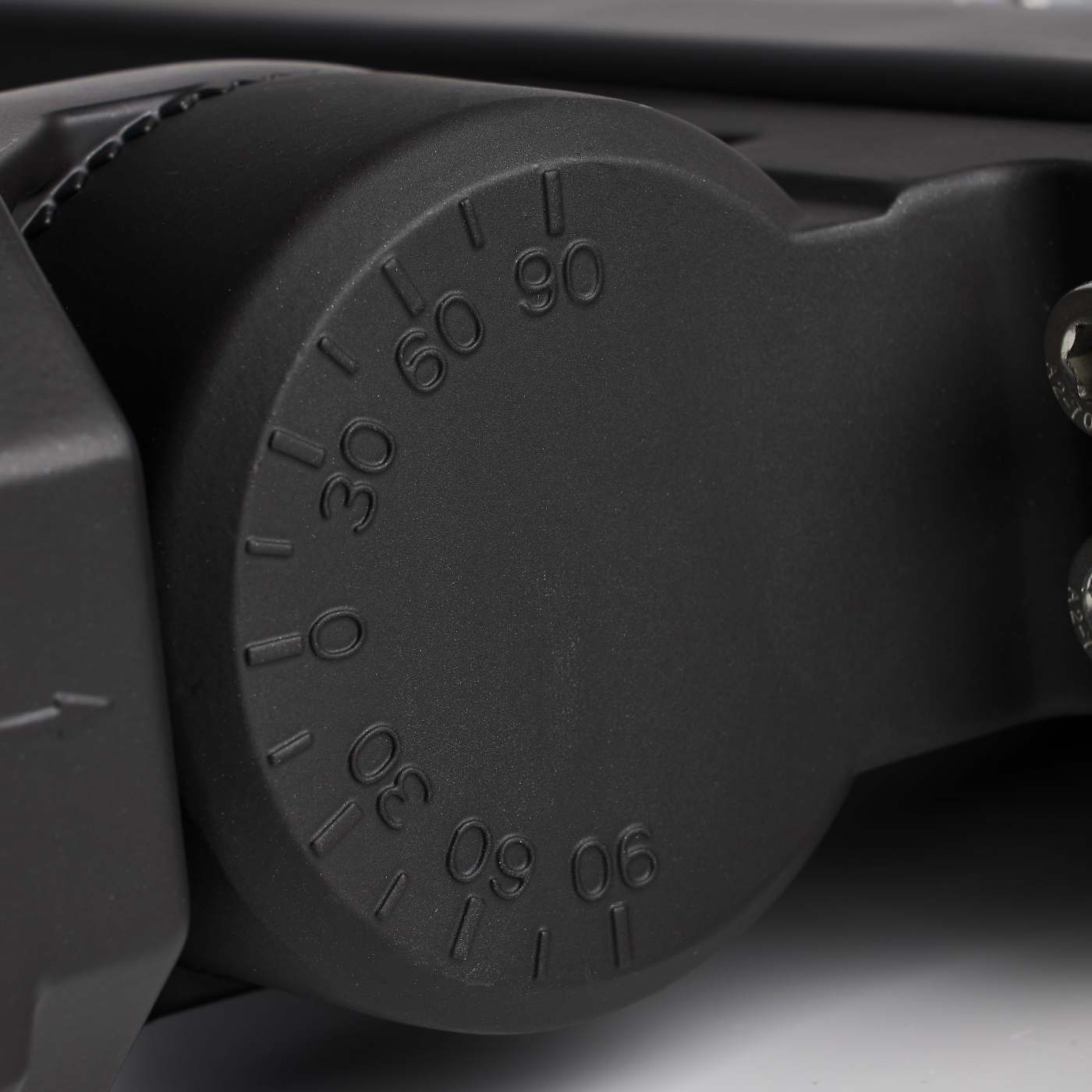 Close-up of a black adjustable wrench handle with measurement markings.