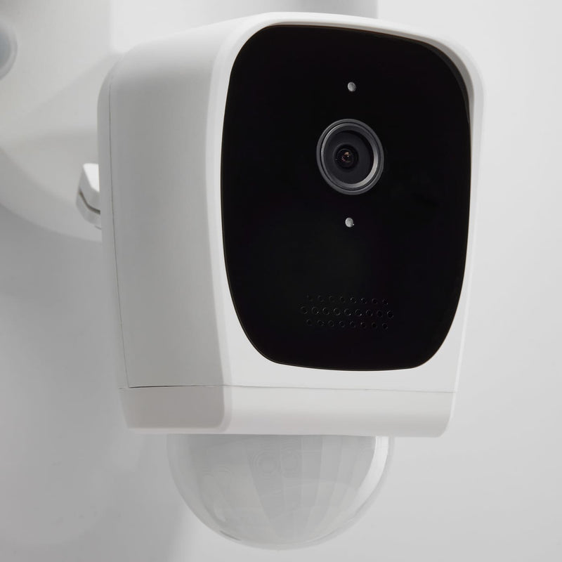 Smart home security camera mounted on a white wall