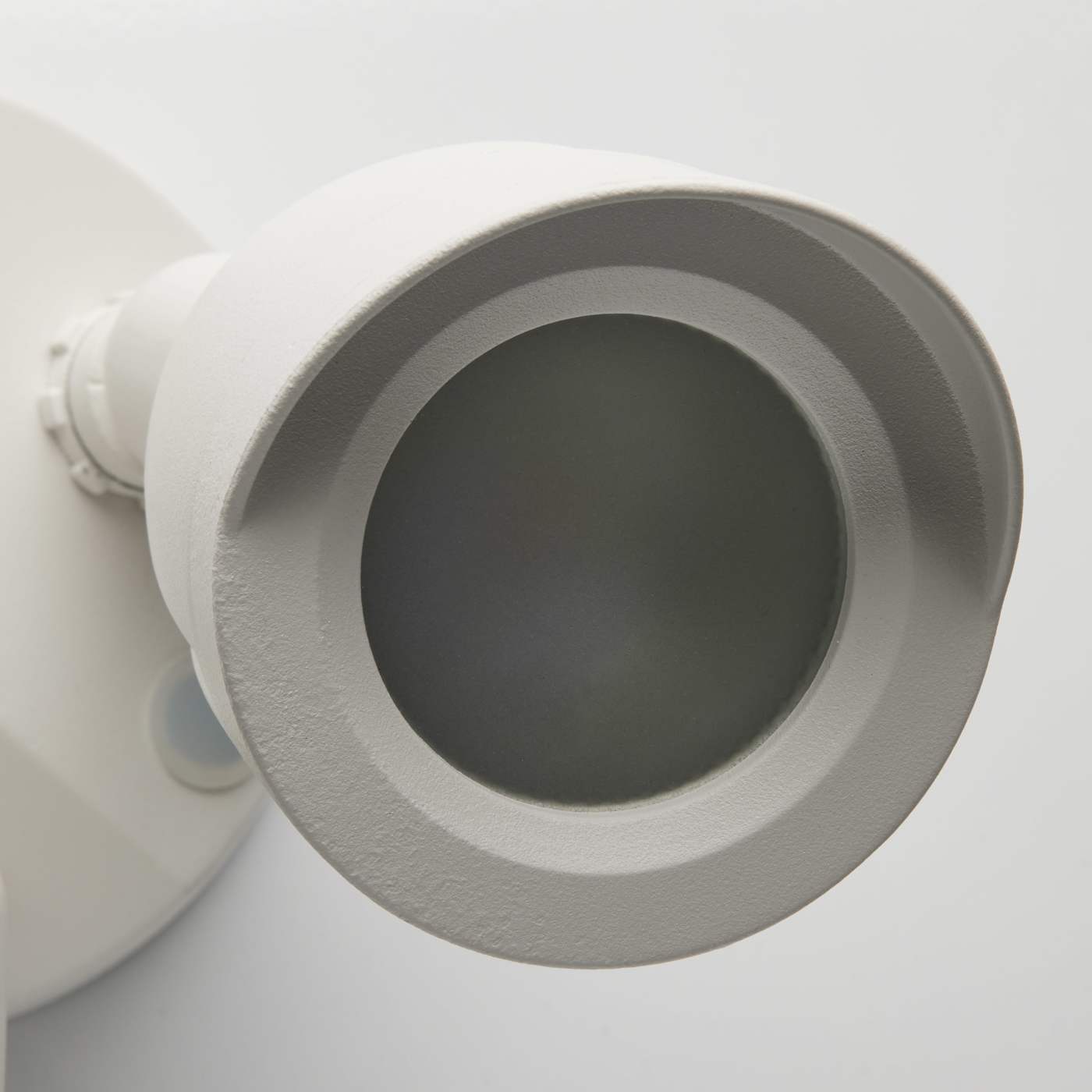 Close-up of a white ceiling light fixture on a white background