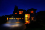 Modern house with illuminated windows at night
