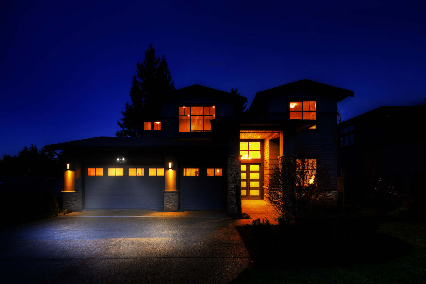 Modern house with illuminated windows at night