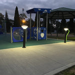 Blue vandal resistant solar bollard light with white and green accents emitting 588 lumens at 2300K-6500K