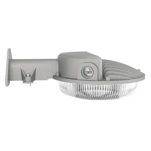 Gray outdoor wall-mounted dusk to dawn security light with ribbed housing, clear glass lens, and photocell included