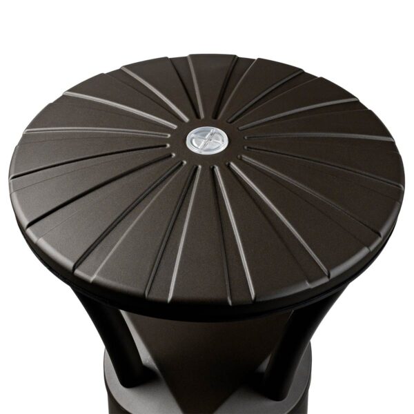 Black circular patio table with textured ribbed top and central silver emblem shown alongside bronze led bollard light with selectable wattage and cct