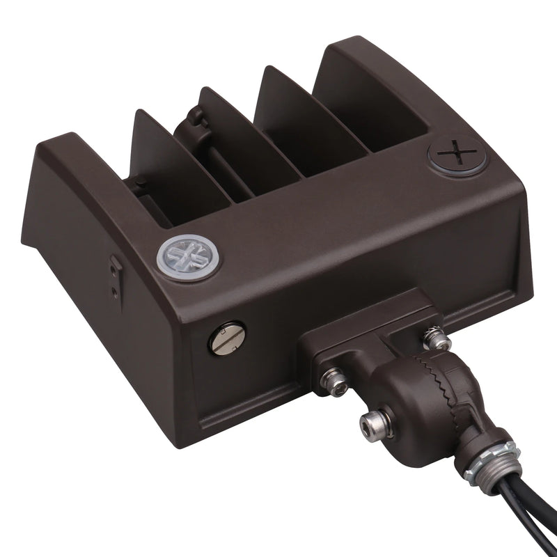 A dark brown marine electronic component, likely a battery charger or alternator, featuring a ribbed metal heat sink, terminal screws, and a black cable connector with a metal terminal block, shown on a white background.