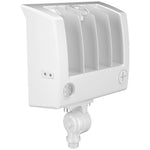 A white outdoor wall-mounted light fixture with a slanted housing, vertical louvers, a circular lens, and a mounting bracket at the bottom, shown on a plain white background.
