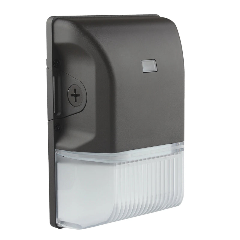 A wall-mounted outdoor light fixture with a matte black top housing a small rectangular sensor or label, and a ribbed clear lower housing, shown on a plain white background.