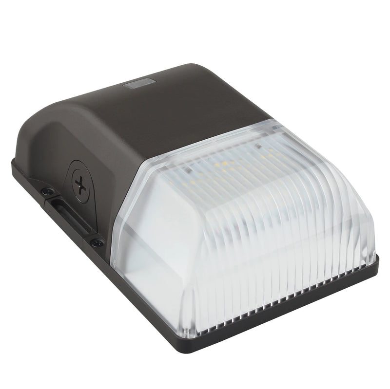A modern outdoor LED light fixture with a dark charcoal gray housing and a ribbed clear acrylic lens, shown on a solid white background.