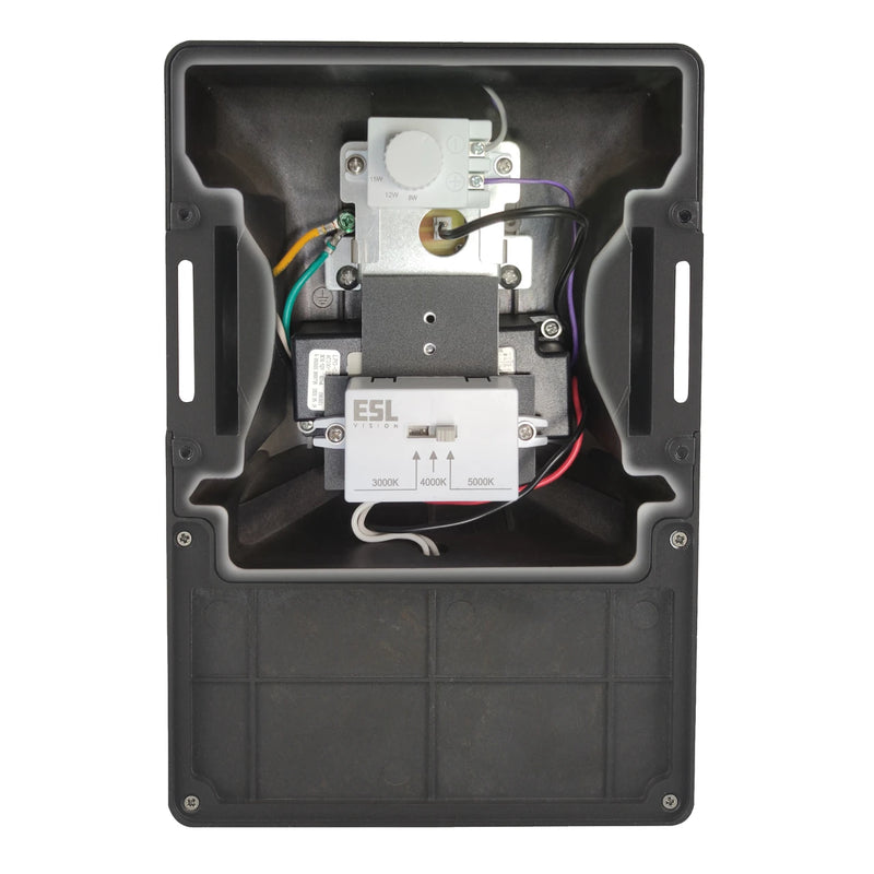 An open black plastic electrical junction box showing internal wiring and components, including a white E5L relay and a white rotary switch, photographed against a solid white background.