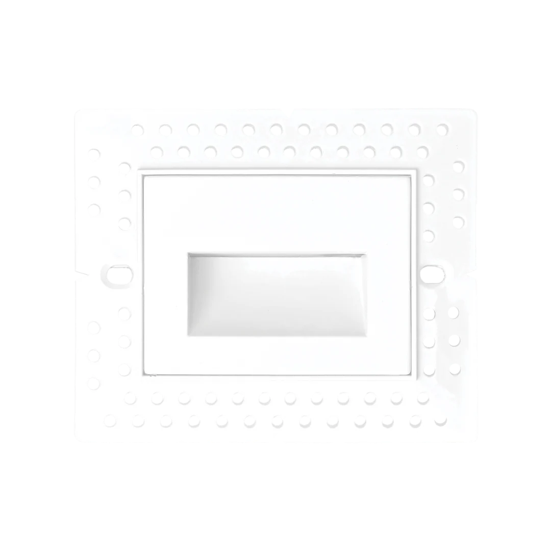 A white recessed light fixture cover plate with a circular mounting pattern of small dots around the border and a central rectangular recess.