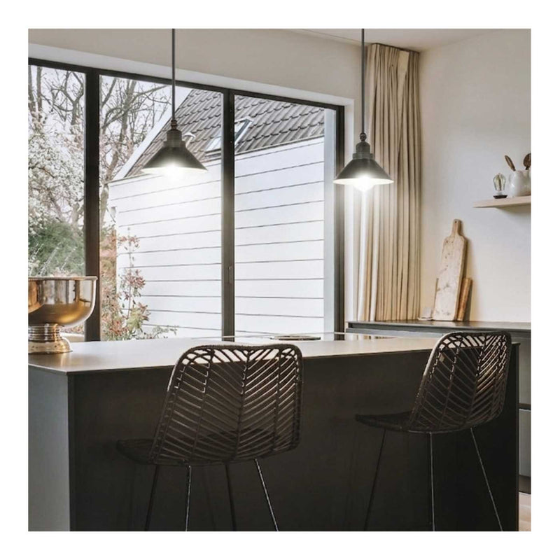 Modern kitchen with a large window, pendant lights, and black chairs.