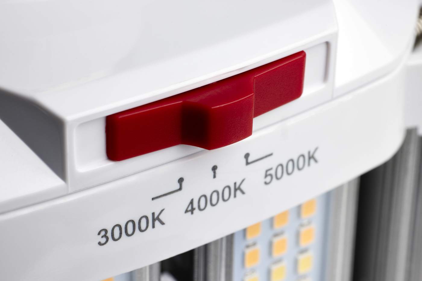 Close-up of a white LED light fixture showing a red switch slider and temperature labels for 3000K, 4000K, and 5000K.