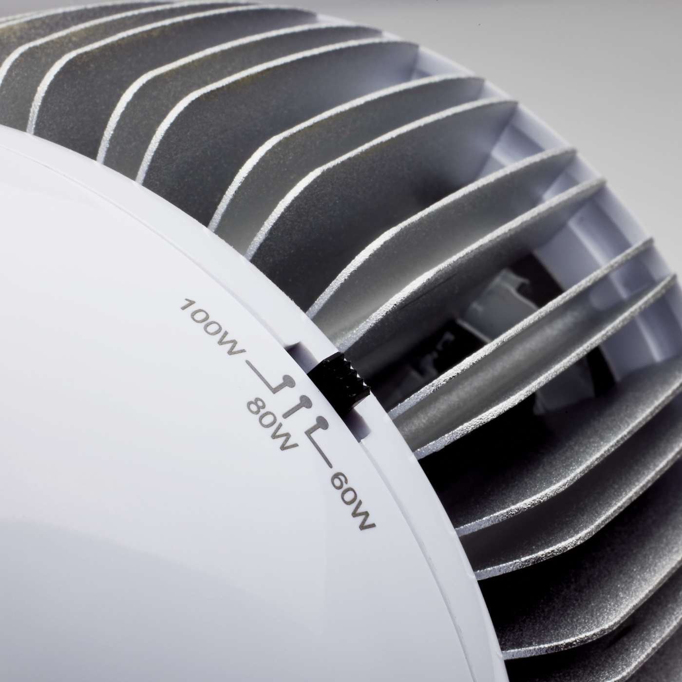 Close-up of a white LED Hi-Bay and Low  Bay light showing its power settings labeled 100W, 80W, and 60W.