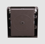 Bronze outdoor wall pack light with a central circular component on a gray background