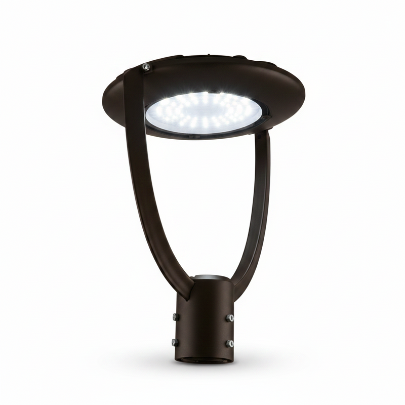 A modern black post top light fixture with a circular shade and curved support arms, shown against a solid light gray background.