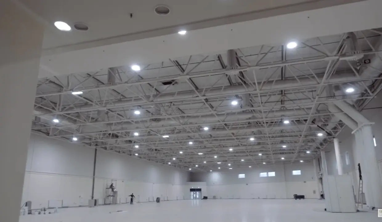 Aries G6 LED UFO high bays lighting an aviation hangar with aircraft and exposed white roof structure