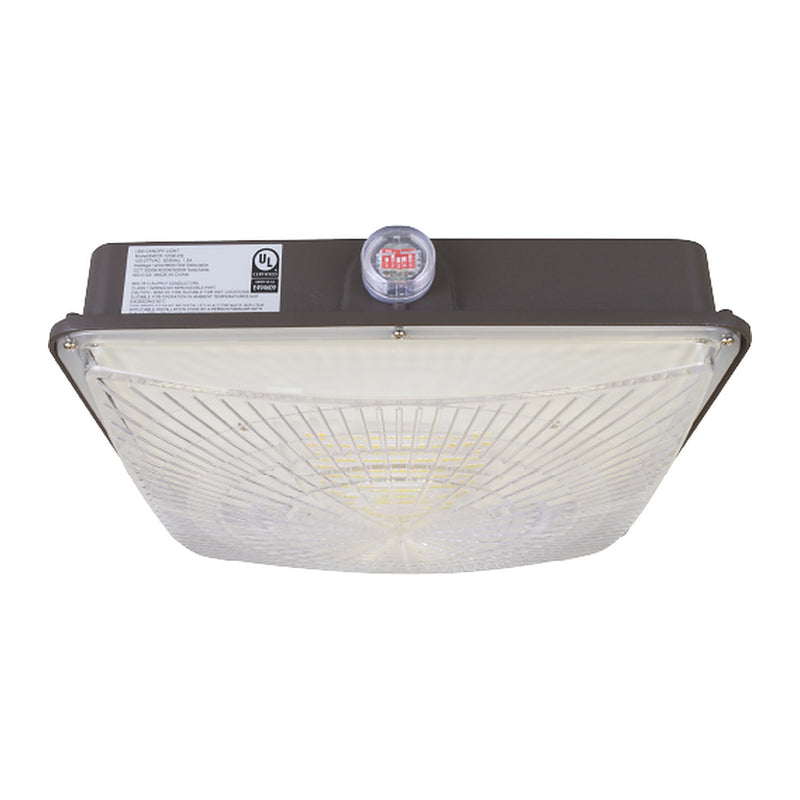 Square LED canopy light with dark bronze housing, clear prismatic lens, and a selector switch under a clear cover on top