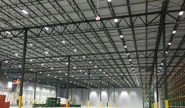 Large industrial warehouse with high ceilings and high bay lights