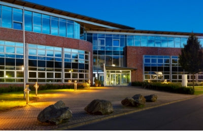 Campus lighting on exterior school building at night