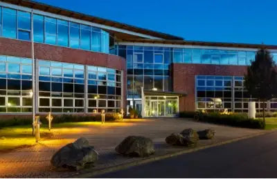 Campus lighting on exterior school building at night