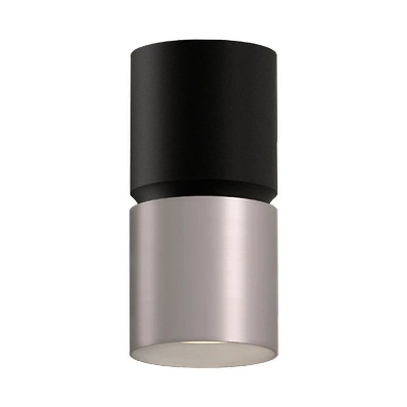 A modern cylindrical wall light fixture with a matte black upper section and a brushed nickel lower section, shown against a plain white background.