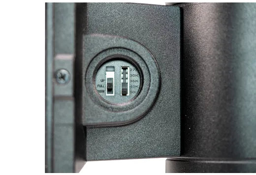 Close-up detail of a cylindrical wall light focusing on the objective lens cover adjustment mechanism, showing a textured dark gray metal body and a silver adjustment dial.